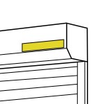 На багажнике с левой стороны 